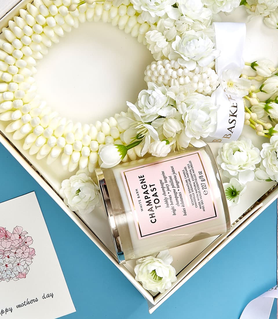 Luxe white floral garland gift set with jasmine buds, scented candle, and Mother's Day greeting card in premium presentation