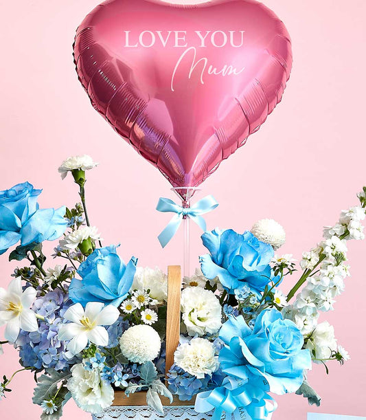 Pink heart balloon and blue-white rose basket with lilies, perfect for Mother's Day