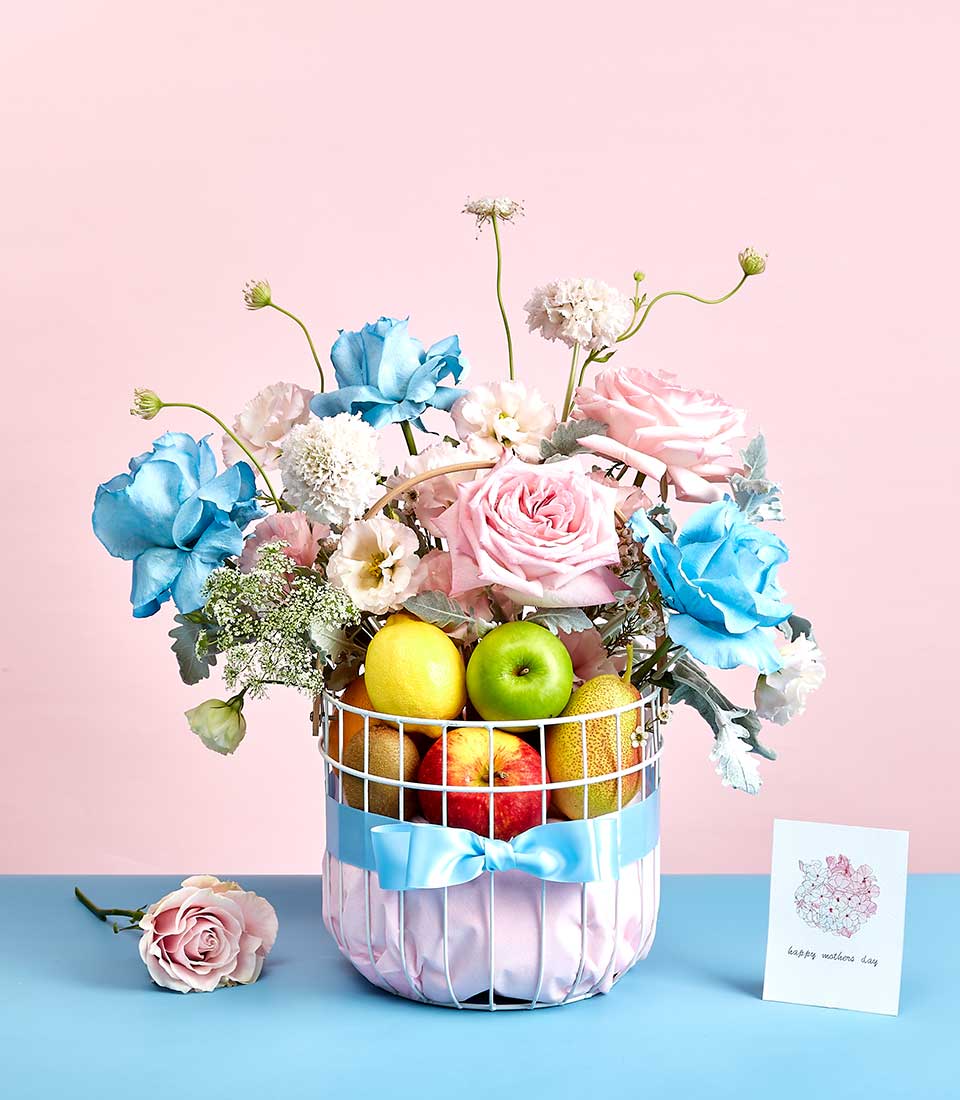 Pink and blue rose arrangement with fresh fruit gift basket for Mother's Day