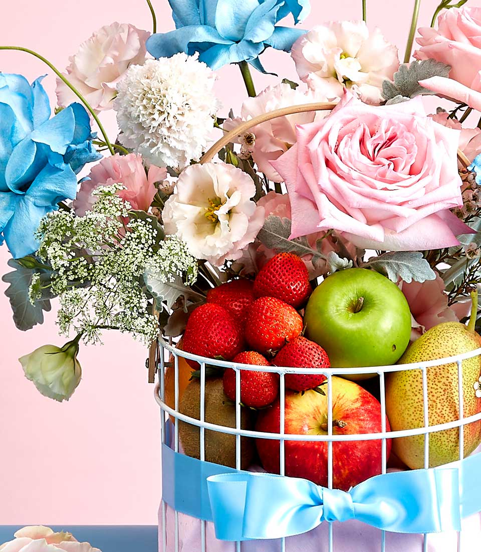 Deluxe flower and fruit gift basket with light blue roses, pink rose, and fresh strawberries, apples for Mother's Day