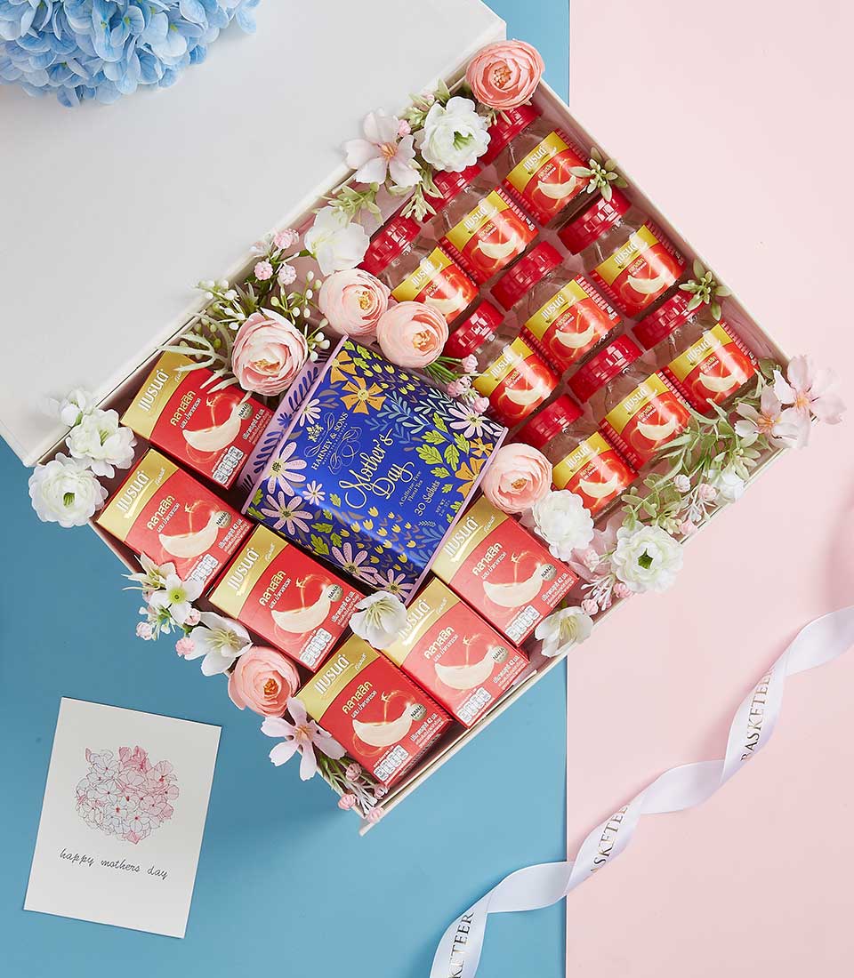 Premium bird's nest gift box with luxury bottles and tea for Mother's Day, pink and white flowers, elegant presentation