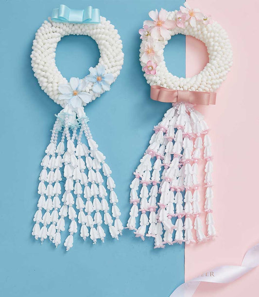 White and pink Phuang Malai garlands with cascading florals, perfect for Mother's Day gifting