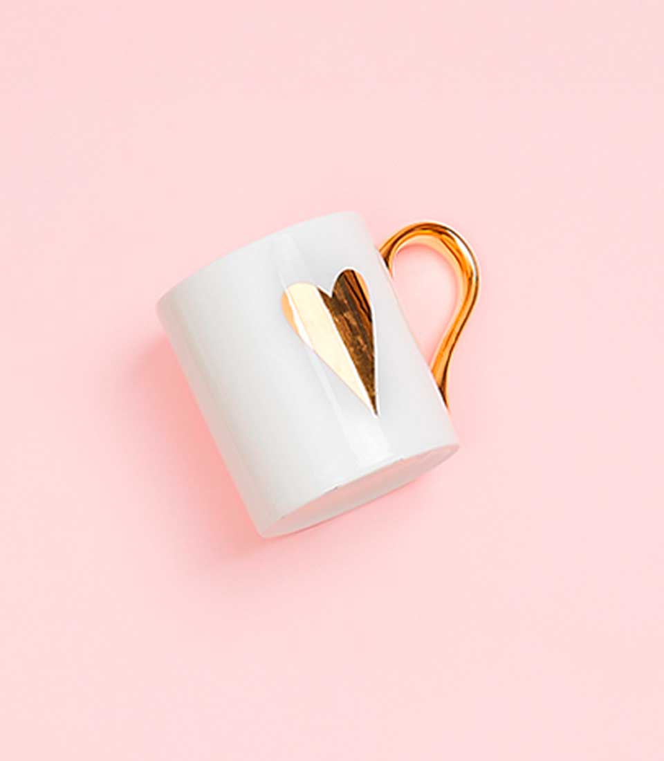 White ceramic mug with gold heart design and handle, Mother's Day gift
