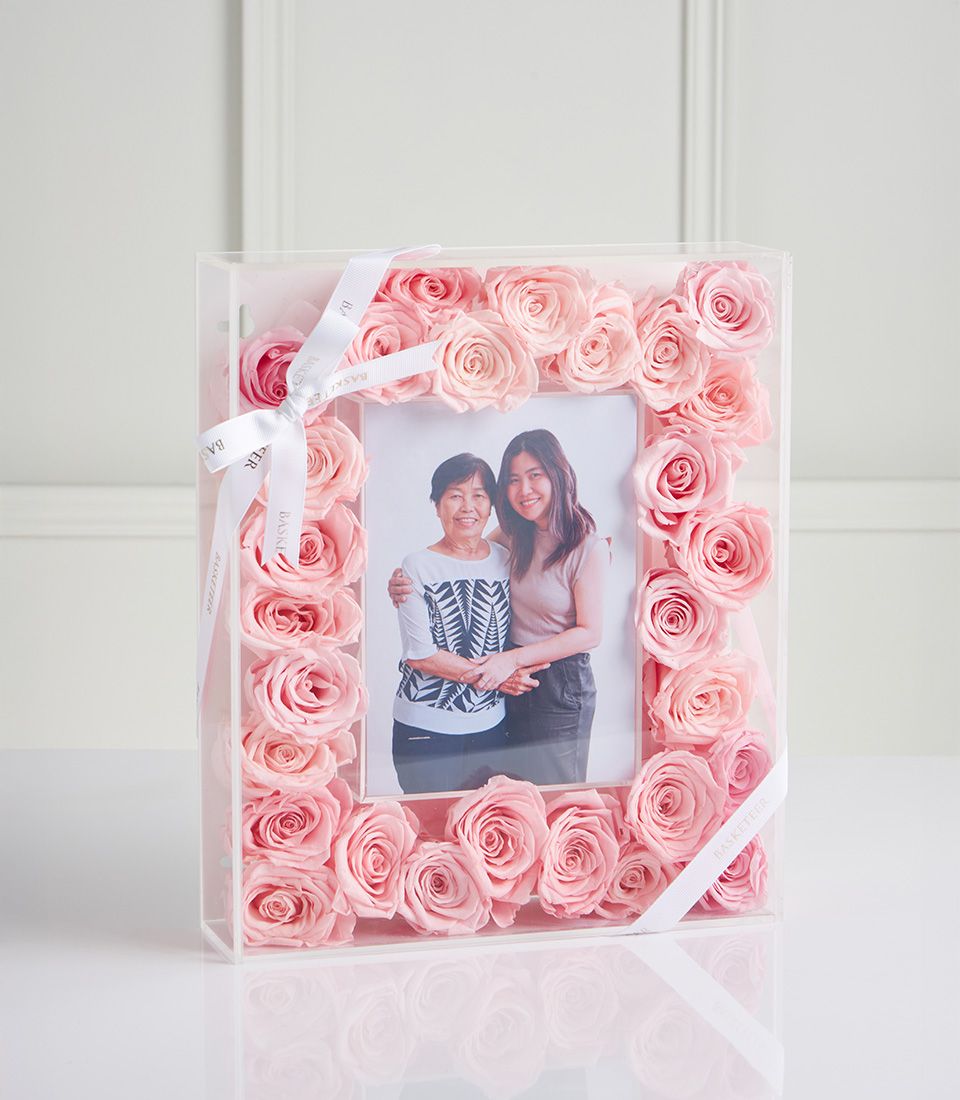 Pink preserved roses surrounding personal photo frame in acrylic gift box for Mother's Day