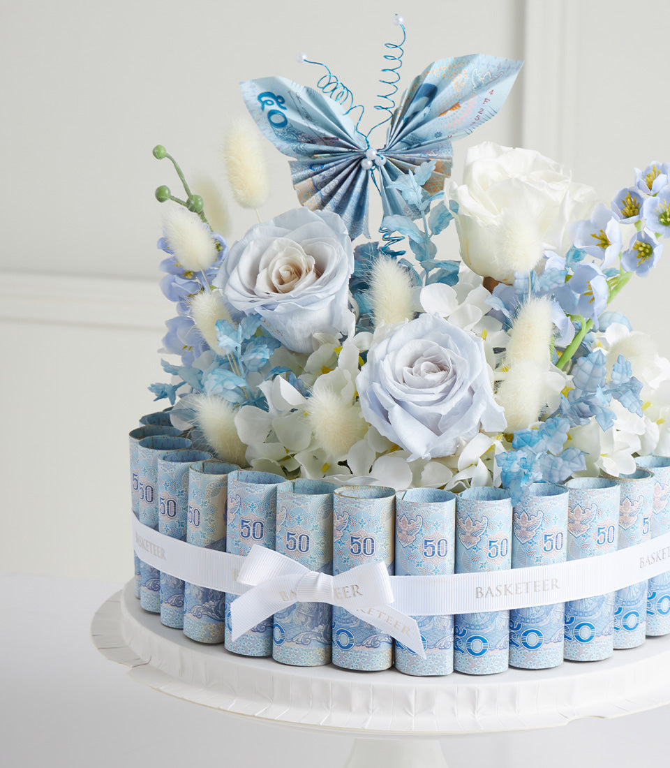 Blue rose and white flower money bouquet with rolled currency base and butterfly detail for Mother's Day gifting