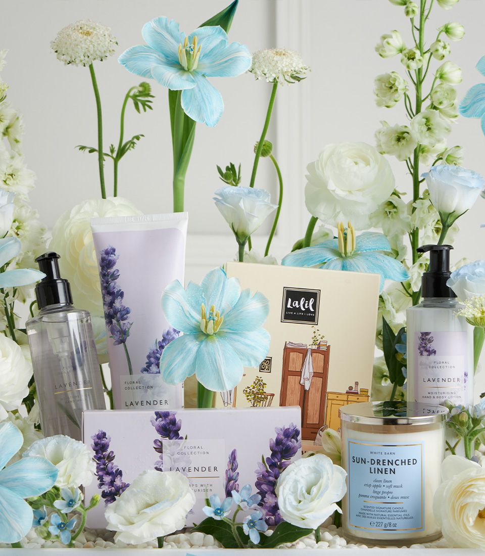 Lavender spa gift basket with hand wash, lotion, candle and fresh white flowers for Mother's Day pampering