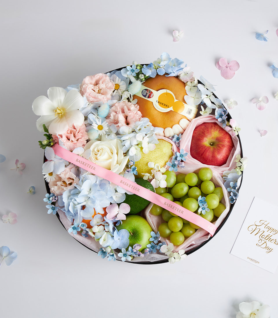 Luxury Mother's Day gift box with fresh fruits, hydrangeas, roses, and carnations in black round packaging