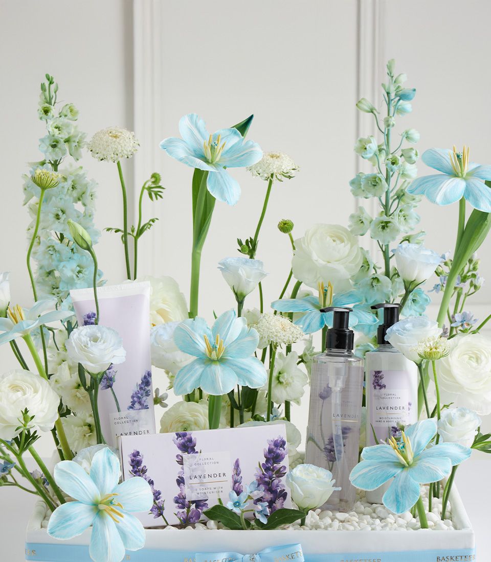 Luxury lavender spa basket with bath products and fresh blue and white flowers for Mother's Day