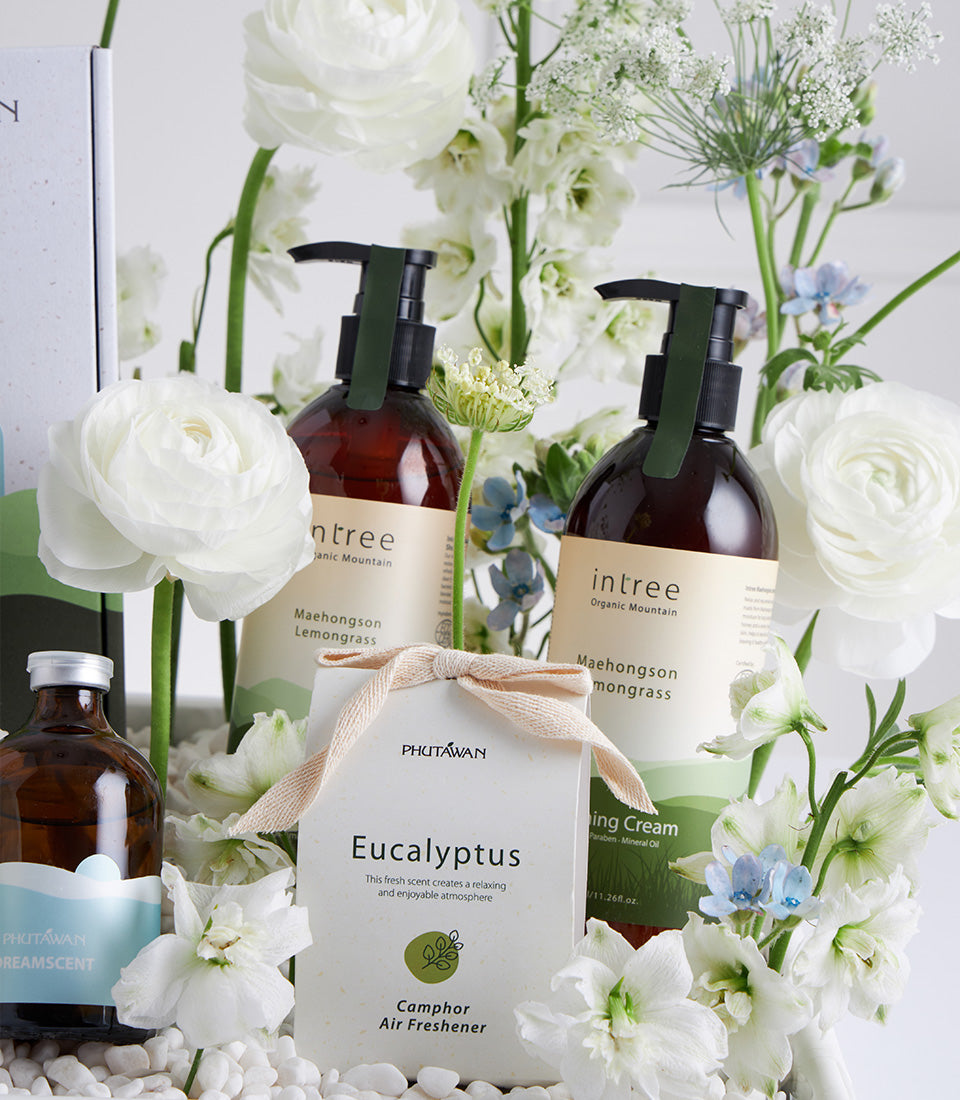 White Bloom Wellness gift basket with organic lemongrass and eucalyptus spa products nestled in fresh white flowers