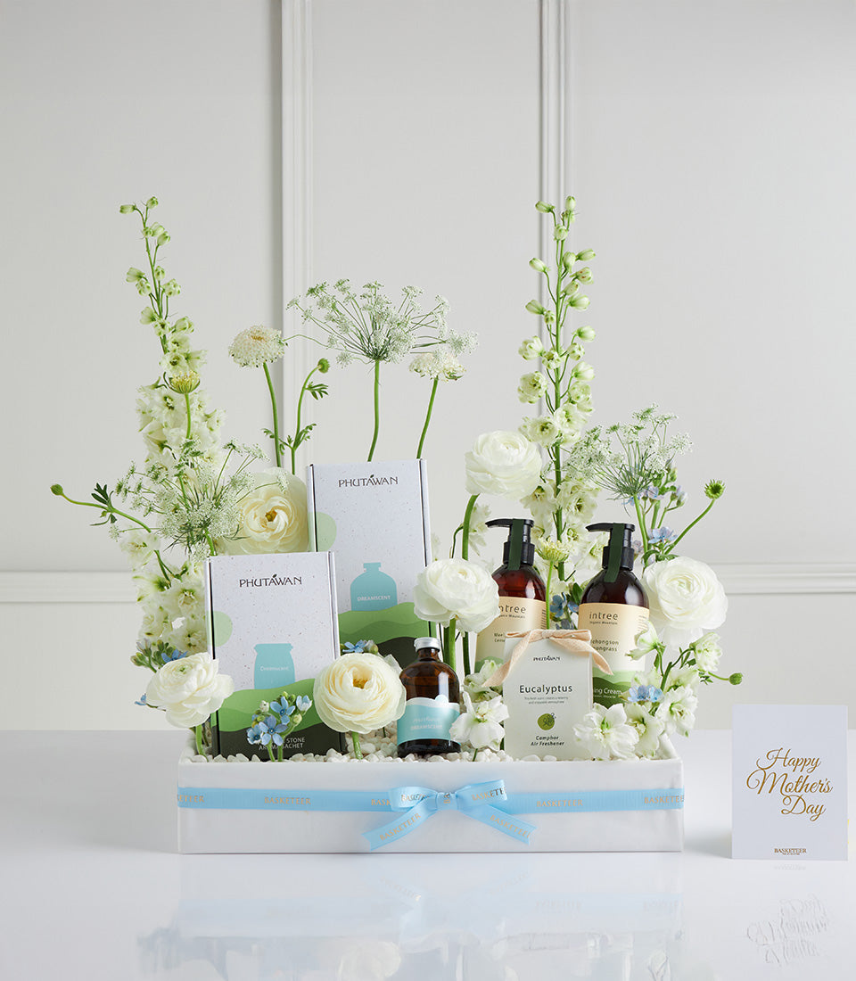 White Bloom Wellness gift basket with spa products, fresh delphiniums and ranunculus for Mother's Day