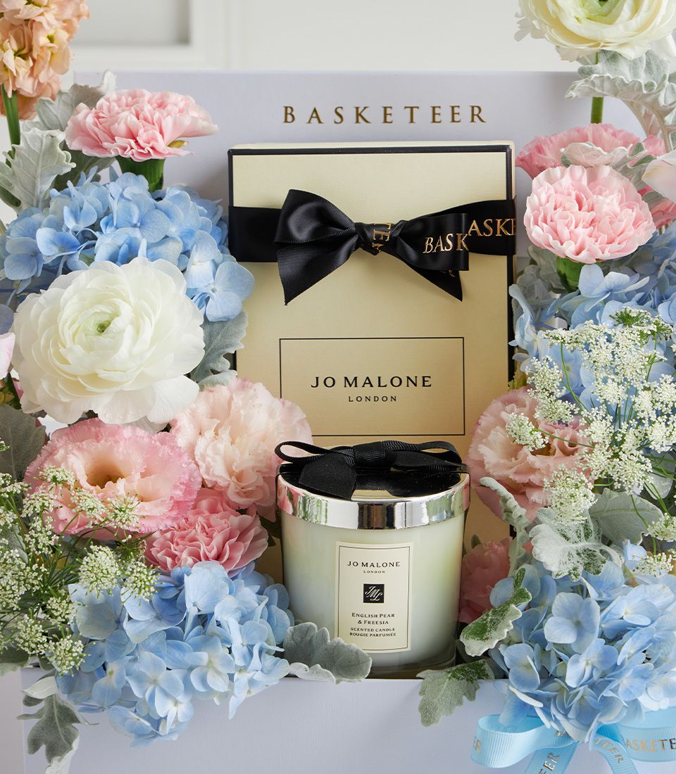 Luxury Mother's Day gift box with Jo Malone candle, pastel hydrangeas, pink carnations, and white ranunculus