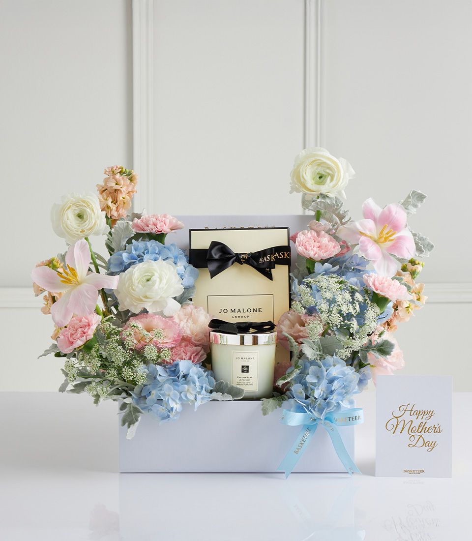 Luxury Mother's Day gift box with Jo Malone candle, pastel hydrangeas, pink carnations, and white ranunculus