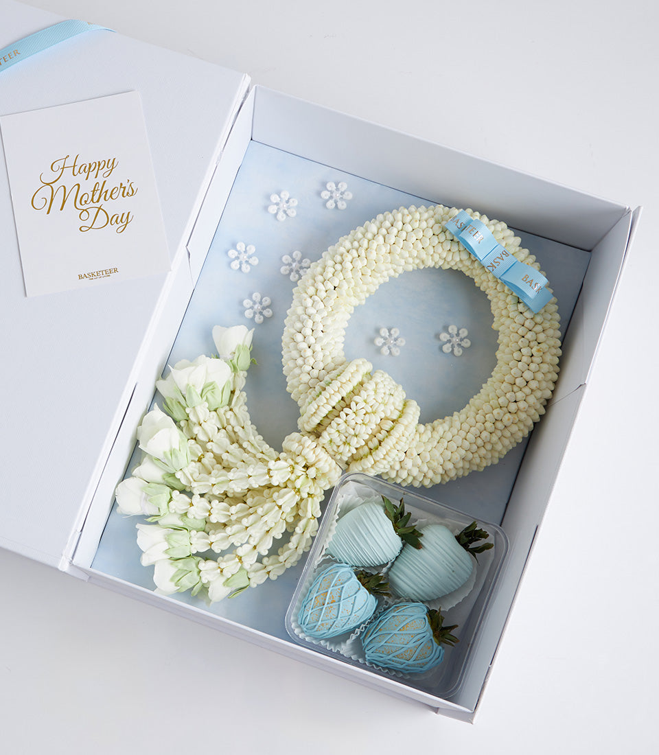 Mother's Day fresh jasmine garland with white flowers, chocolate-covered strawberries, and greeting card in luxury gift box