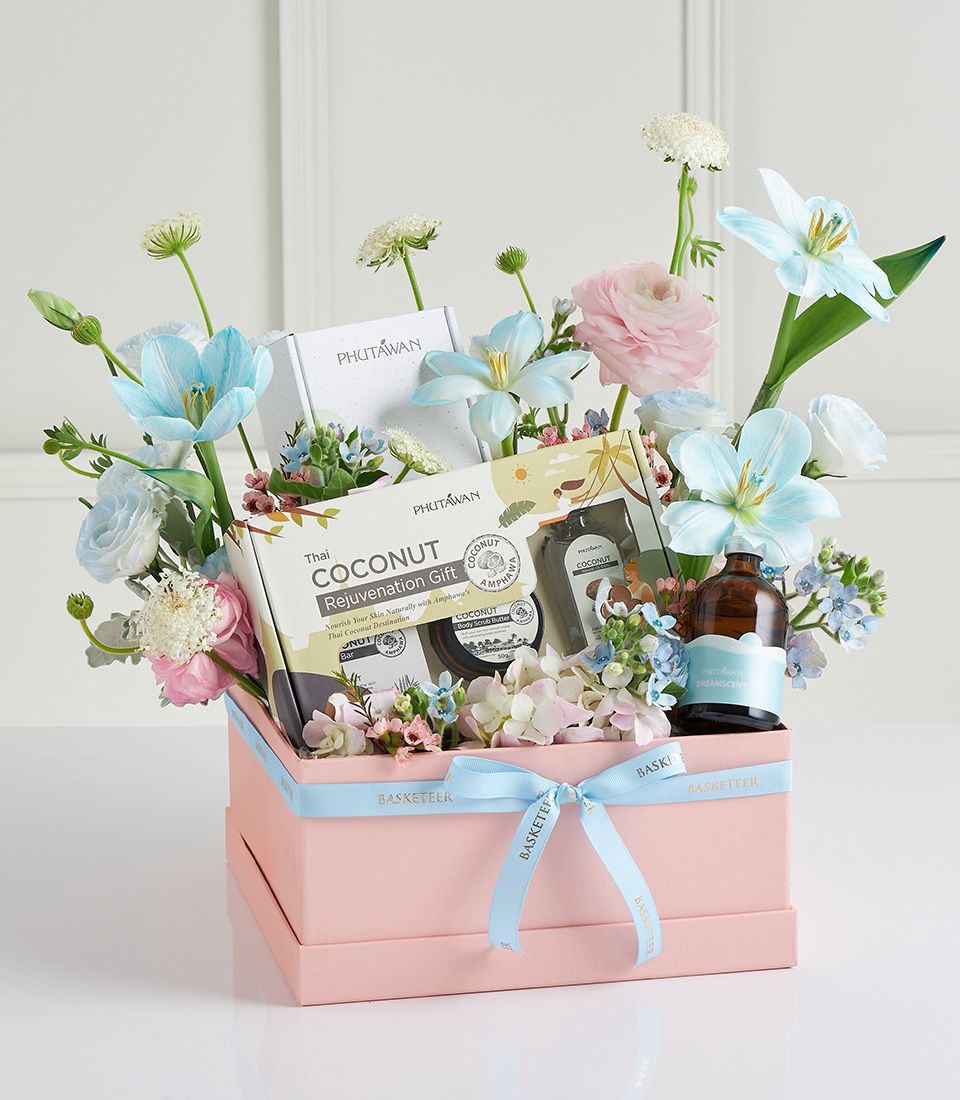 Pastel pink spa gift box with fresh flowers, coconut and aromatherapy products for Mother's Day