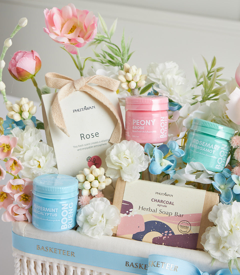 Luxury Mother's Day spa gift basket with herbal soaps, scented jars, and fresh florals