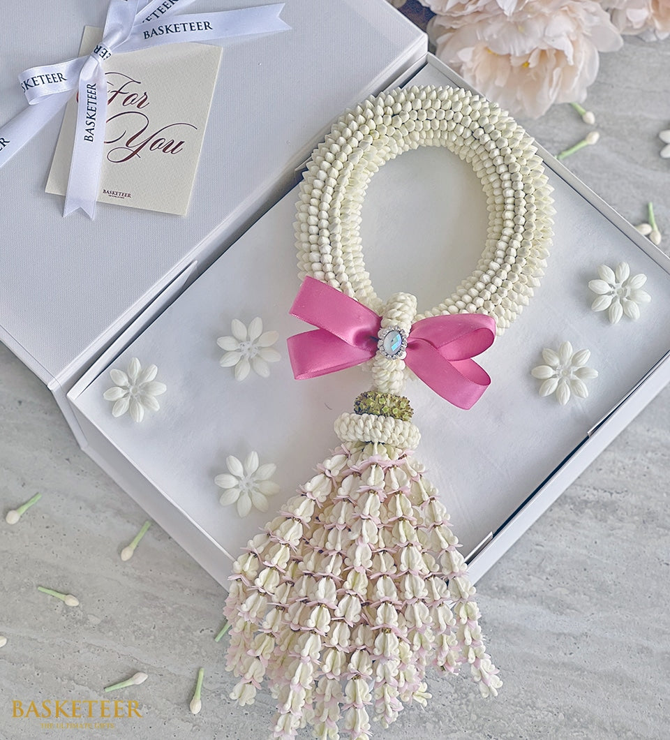 Fresh white jasmine phuang malai garland with pink satin bow in gift box, Mother's Day present