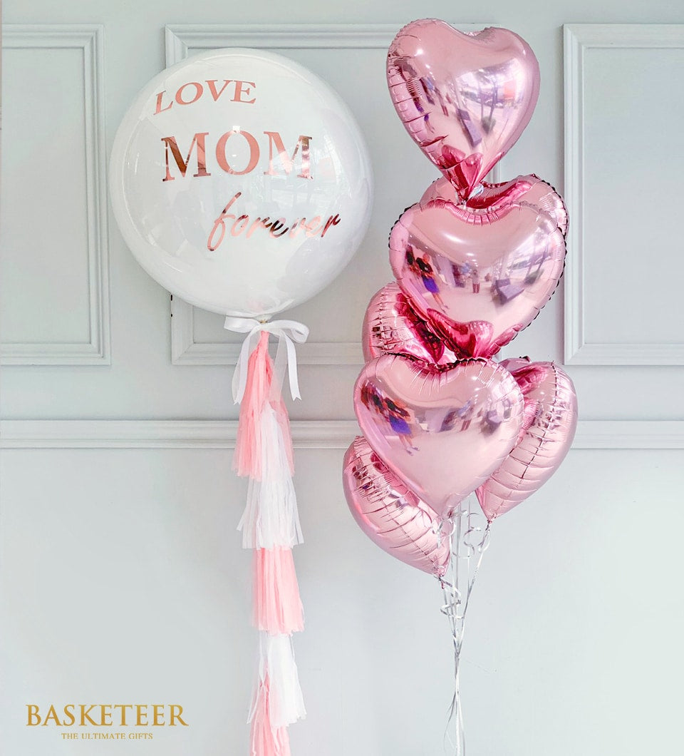 White and pink balloon gift set with rose gold "LOVE MOM forever" message and metallic heart balloons for Mother's Day