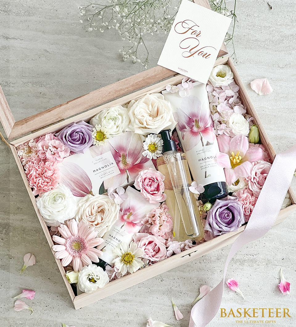 Luxury spa gift box with fresh roses, carnations, and gerberas paired with floral collection bath products for Mother's Day