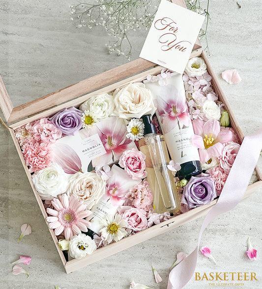 Luxury spa gift box with fresh roses, carnations, and gerberas paired with floral collection bath products for Mother's Day