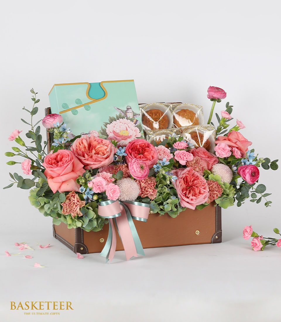 Luxury mooncake and fresh flower gift basket in leather trunk with coral roses, ranunculus, and blue accents for Moon