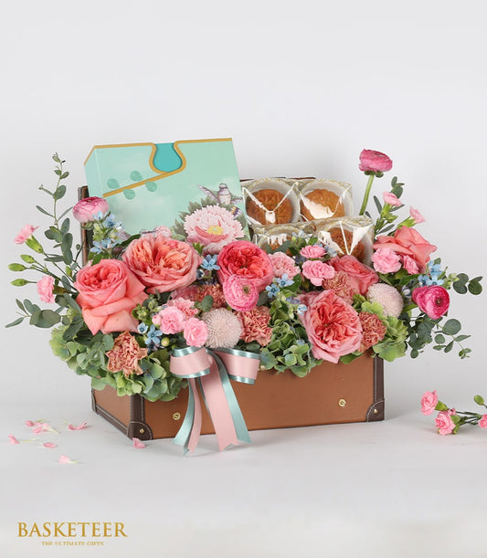 Luxury mooncake and fresh flower gift basket in leather trunk with coral roses, ranunculus, and blue accents for Moon