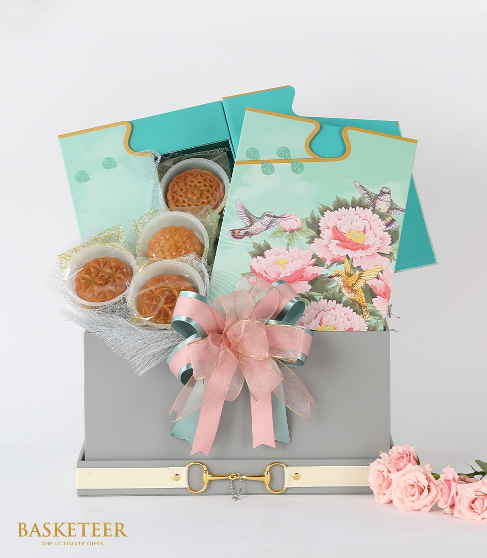 Luxury mooncake gift box with gold clasp, five premium mooncakes, teal cards and fresh pink roses