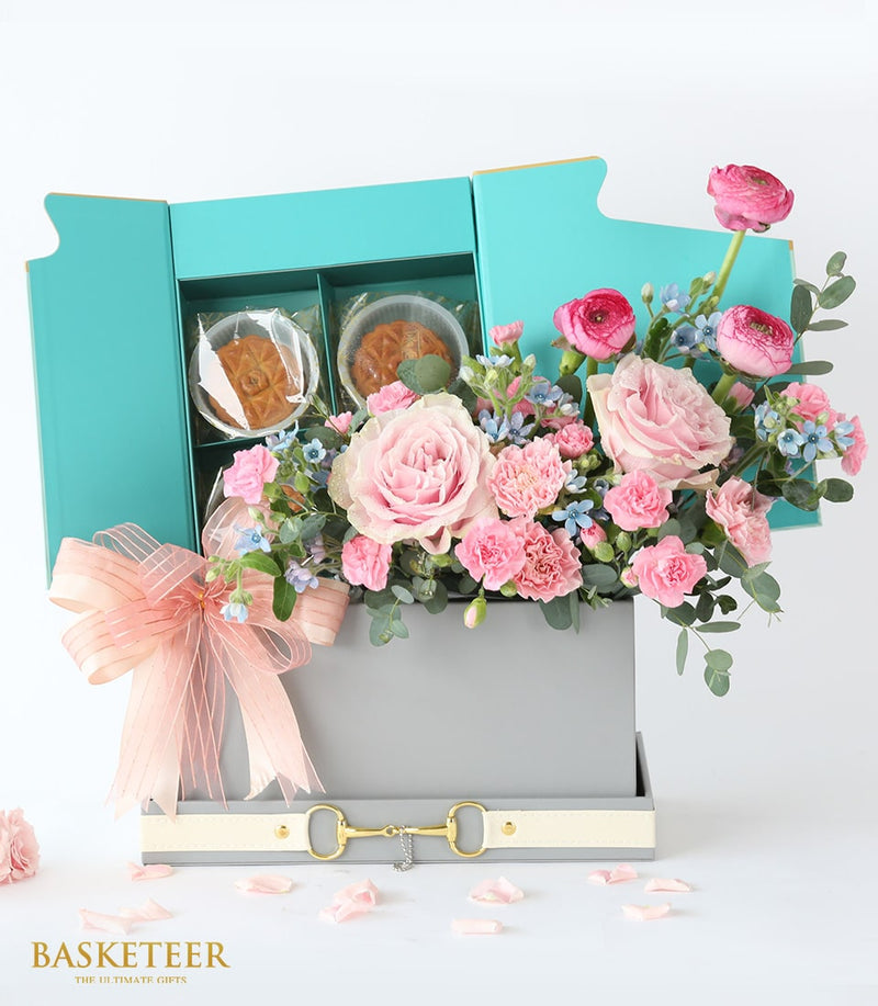 Luxury mooncake and fresh flower gift box with pink roses, carnations, and blue blooms, peach ribbon detail