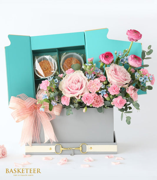 Luxury mooncake and fresh flower gift box with pink roses, carnations, and blue blooms, peach ribbon detail