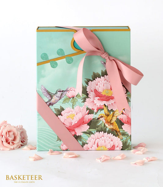 Mint green mooncake gift box with peony and hummingbird design, pink ribbon bow, and rose accents