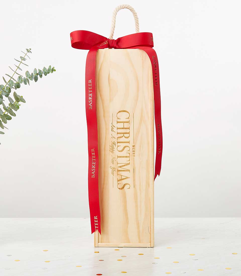 Premium red wines in light pine gift box with ribbon and gold-foil festive engraving