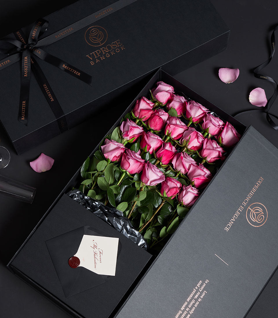 Luxury pink rose Valentine gift box with black packaging, copper branding, and personalized love card