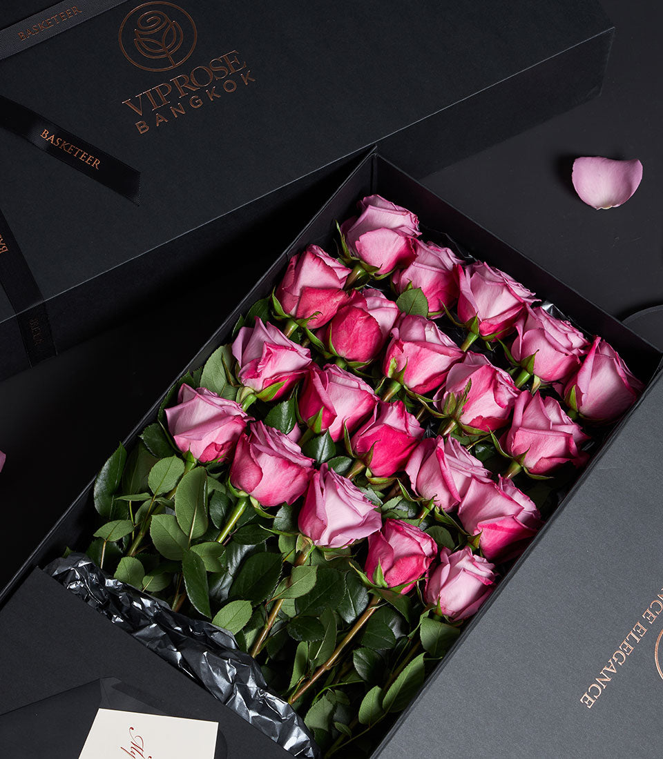 Luxury black gift box with 18-20 fresh pink roses in gradient hues, gold foil logo, Valentine's Day floral gift