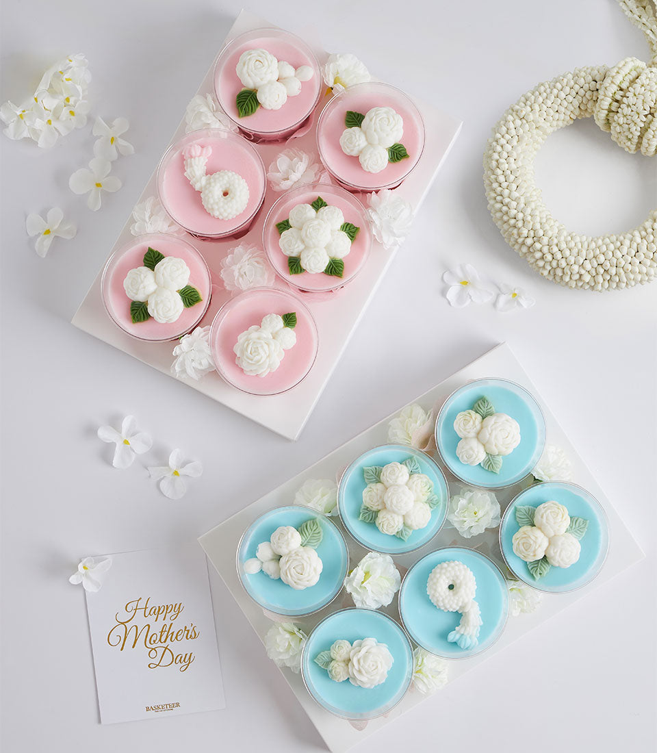Mini coconut jelly dessert set with pink and blue bases, white edible flowers, and Thai Phuang Malai motif for Mother's Day
