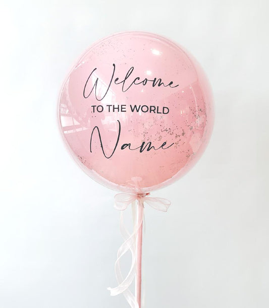 Personalized pink bubble balloon with silver confetti and custom name, welcome baby gift with ribbon bow