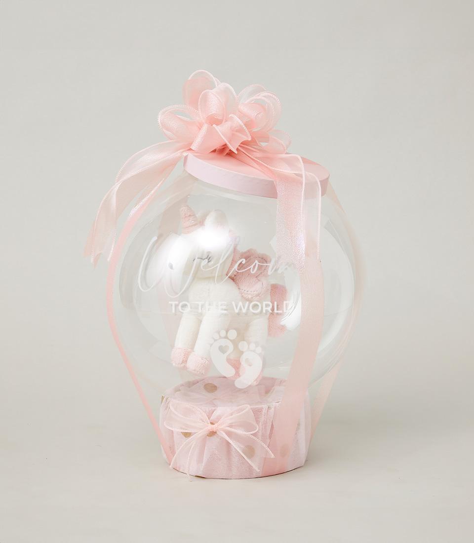 Dreamy Unicorn hot air balloon gift with plush white unicorn, pink polka-dot base, and welcome message for newborn