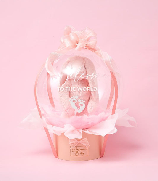 Pink hot air balloon baby gift with plush bunny, newborn welcome hamper by Basketeer