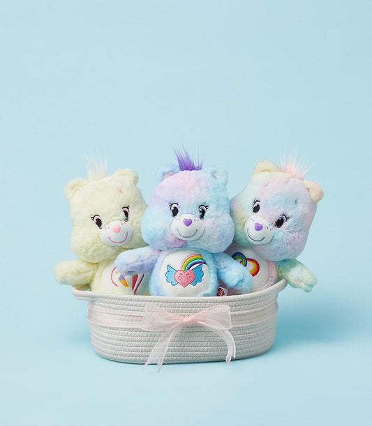 Colorful plush teddy bears trio in woven basket with pink ribbon, pastel birthday gift for kids