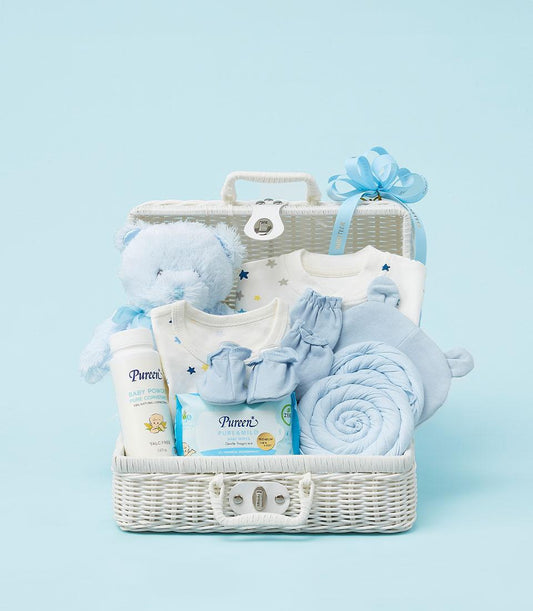 Light blue and white baby gift basket with teddy bear, star bodysuits, mittens, blanket and Pureen essentials