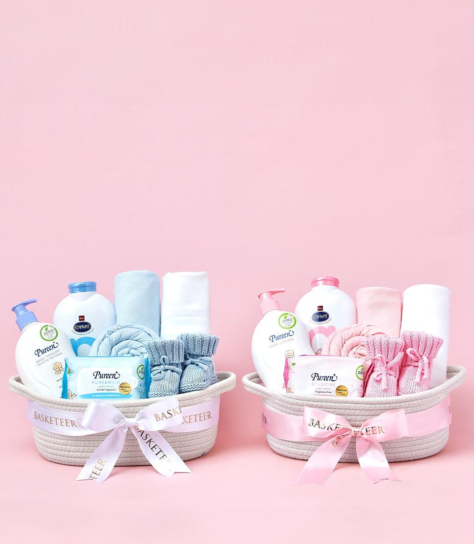 Deluxe baby care gift baskets with wash, lotion, wipes, towels and booties in blue and pink