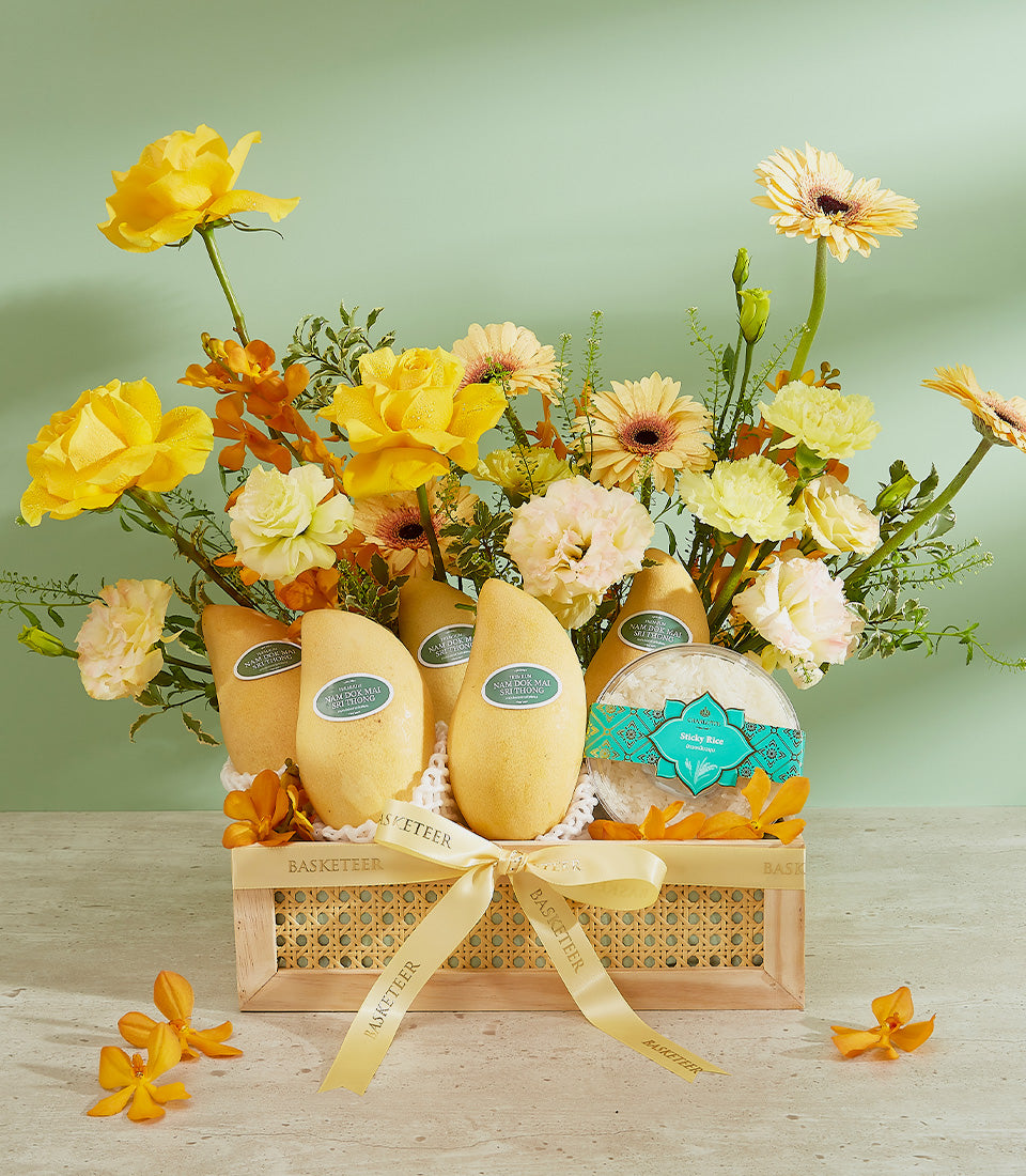 Golden mangoes luxury gift basket with yellow roses, white sticky rice, and tropical blooms