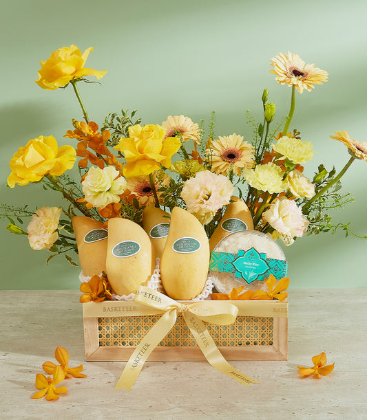 Golden mangoes luxury gift basket with yellow roses, white sticky rice, and tropical blooms