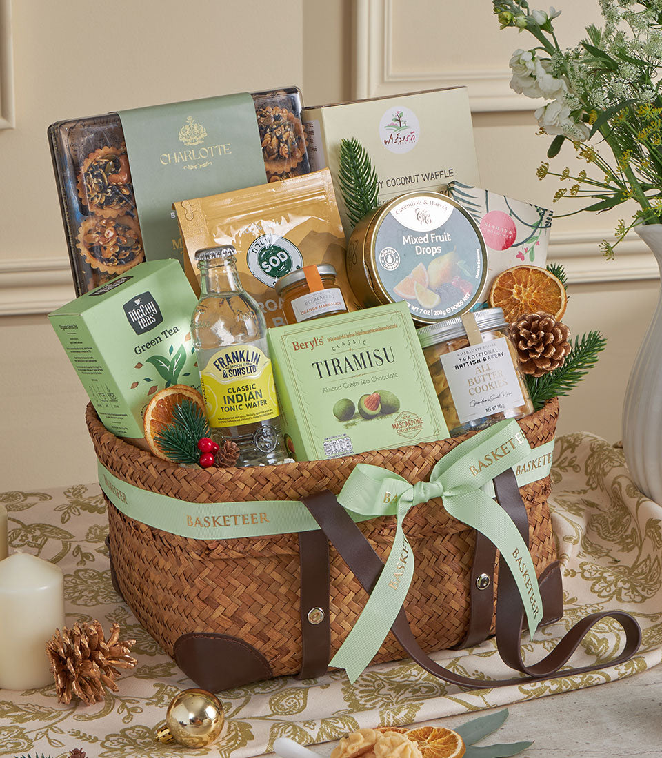 Green Harmony gourmet gift basket with green tea, tonic water, pastries, and artisan treats for New Year celebrations