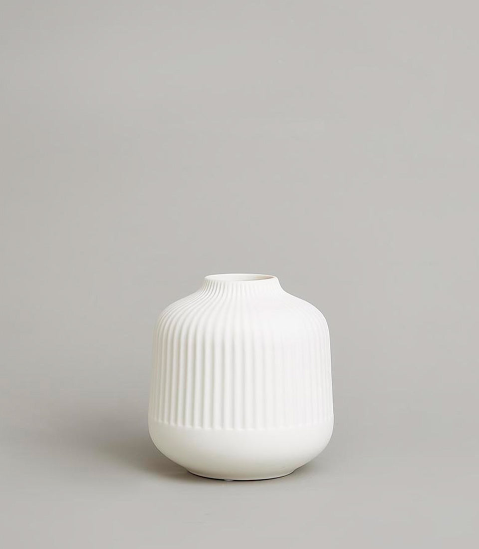 Minimalist ribbed white ceramic vase with tapered neck for fresh flowers or dried arrangements