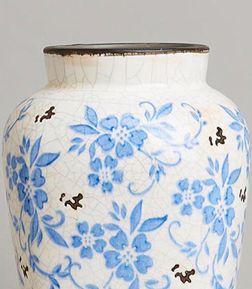 Vintage blue and white ceramic vase with crackled glaze and floral motif