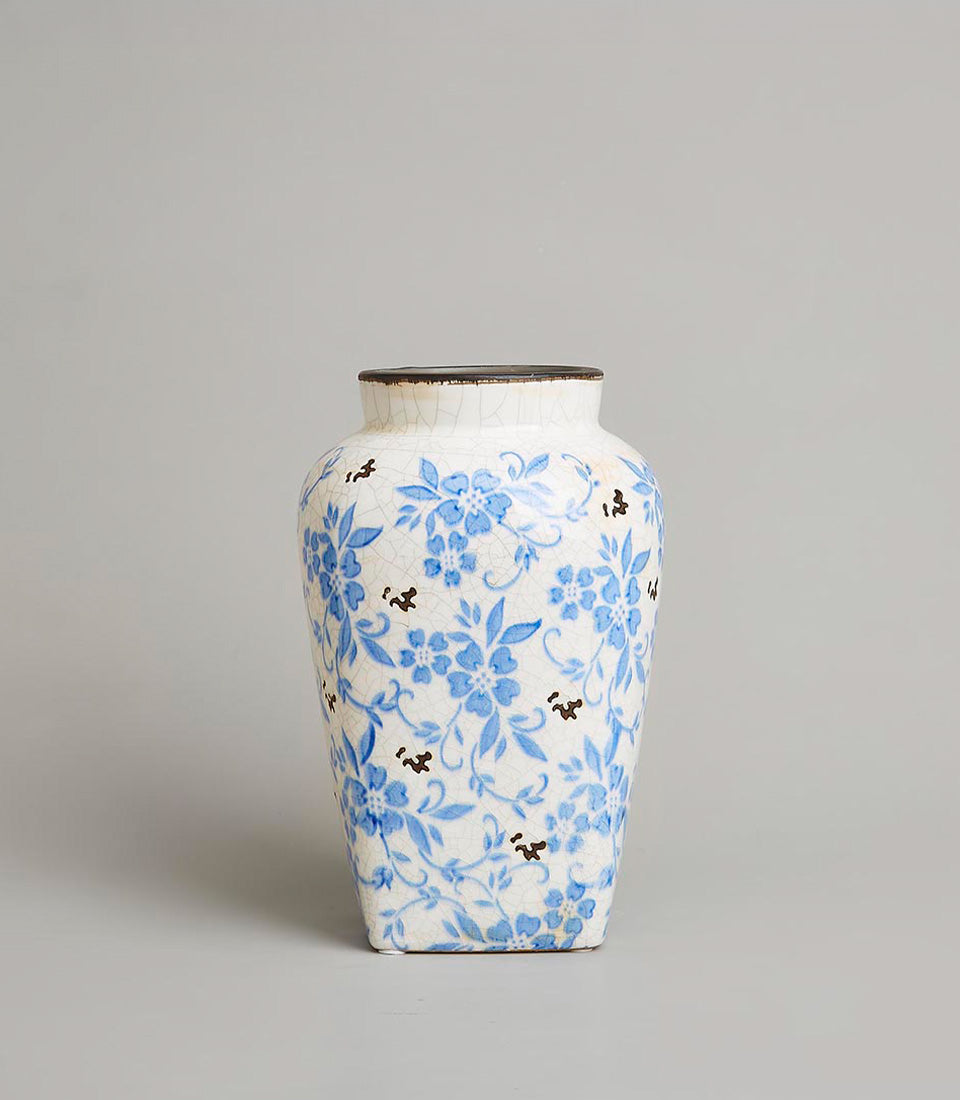 Vintage Bloom white ceramic vase with crackled glaze and blue floral pattern, dark accents
