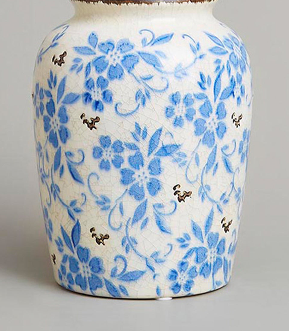 Vintage blue and white ceramic vase with crackled glaze and floral motif
