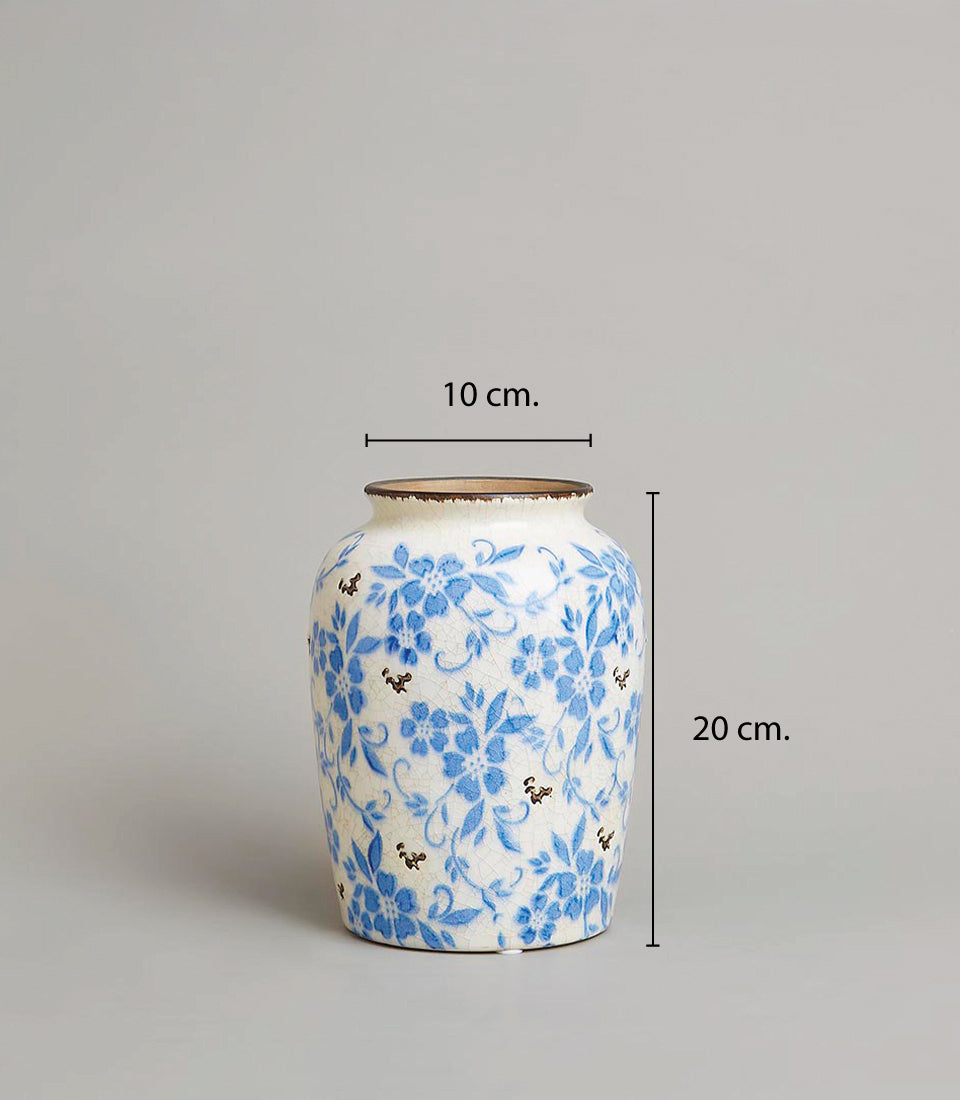 Vintage ceramic vase with white crackled glaze and delicate blue floral pattern