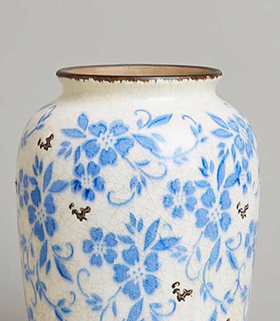 Vintage blue floral ceramic vase with crackled white glaze and bronze rim