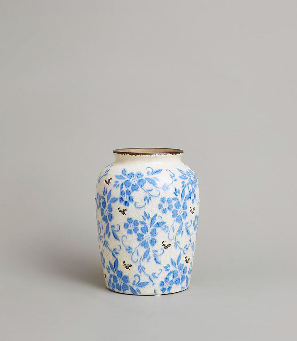 Vintage blue floral ceramic vase with crackled glaze and rustic brown rim