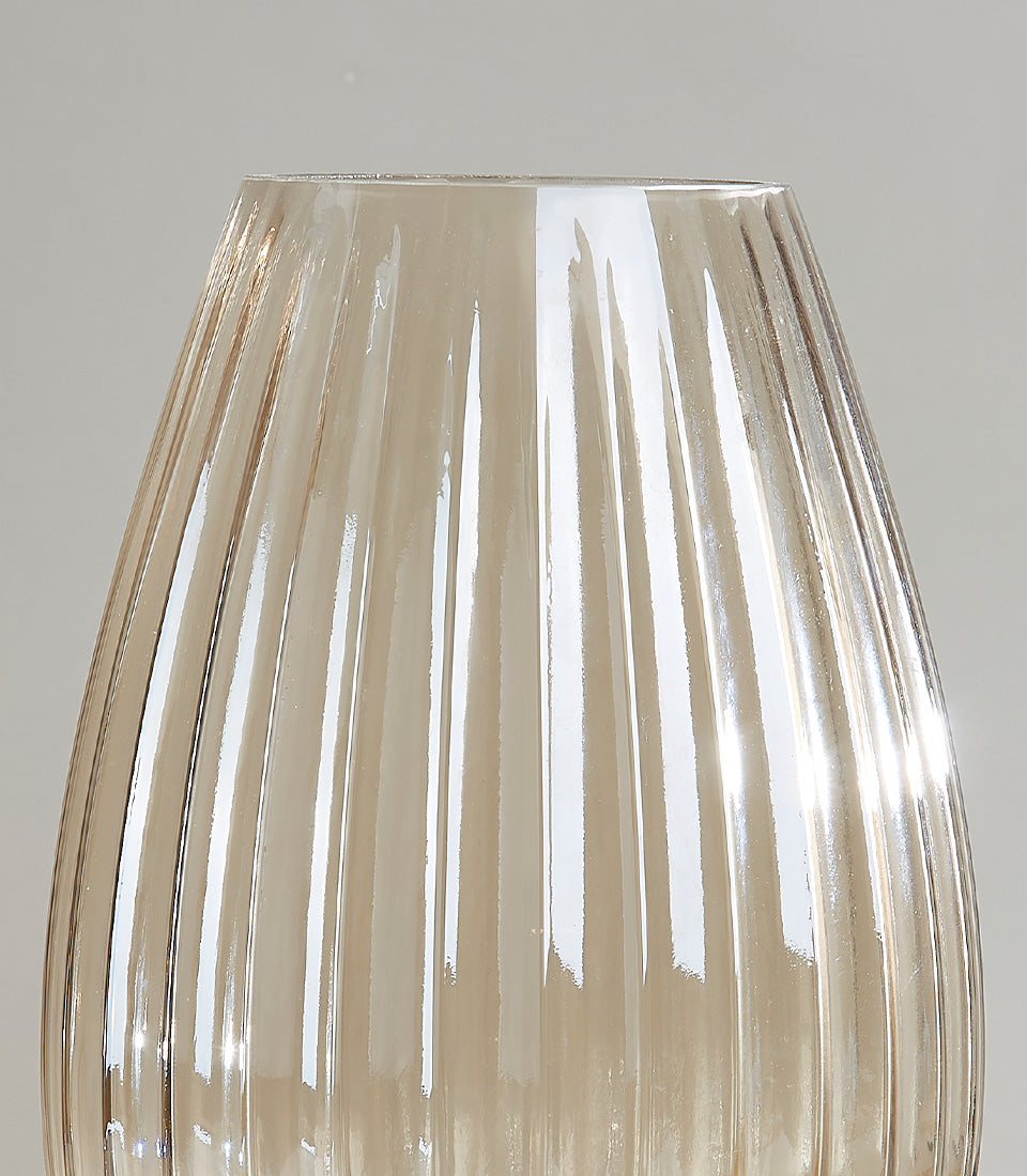 Golden ribbed glass vase with fluted vertical ridges and tapered silhouette for fresh flowers
